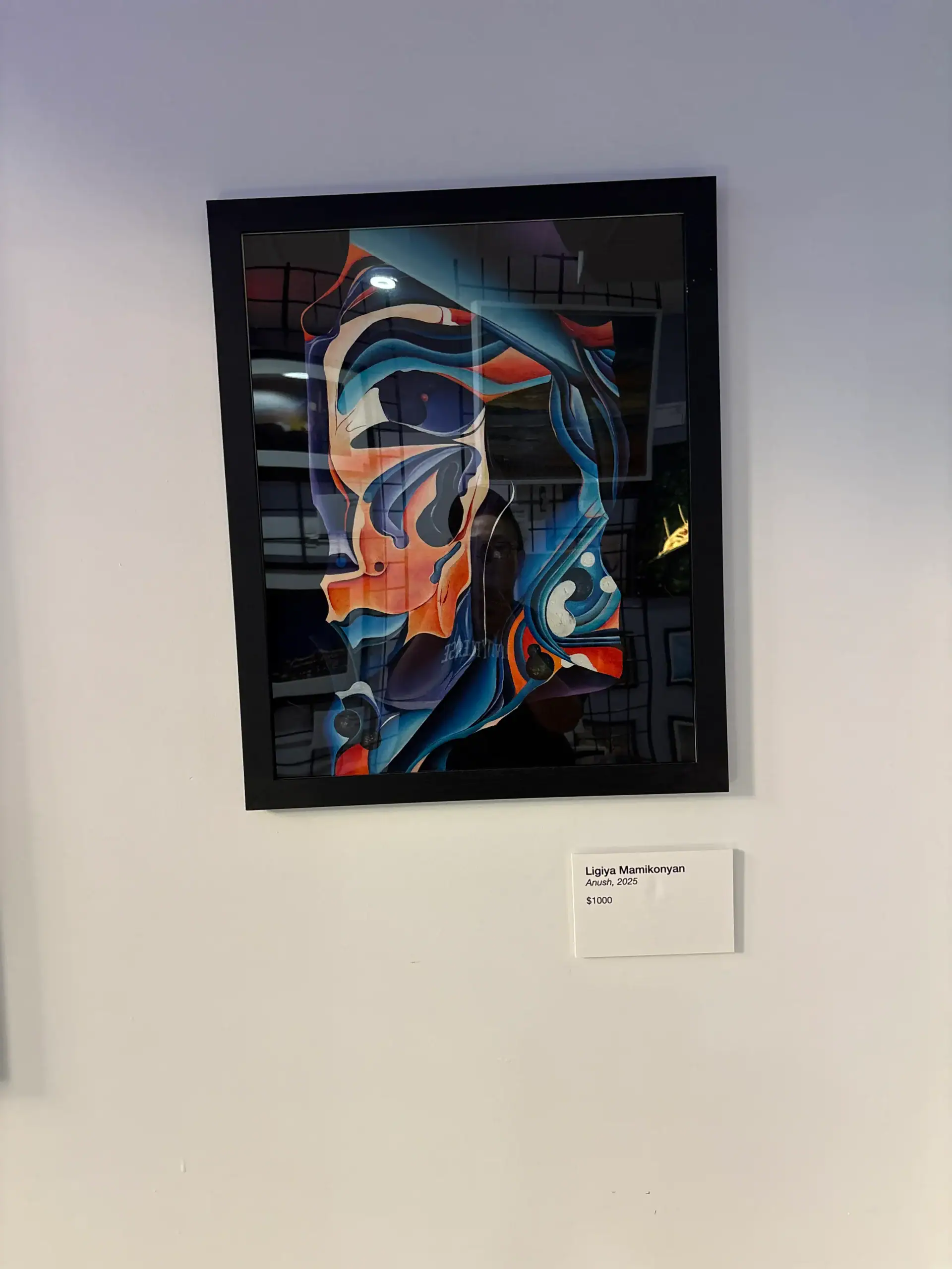 Abstract colorful artwork in a black frame at a NYC Wine Bar & Art Gallery, with visible label and price.