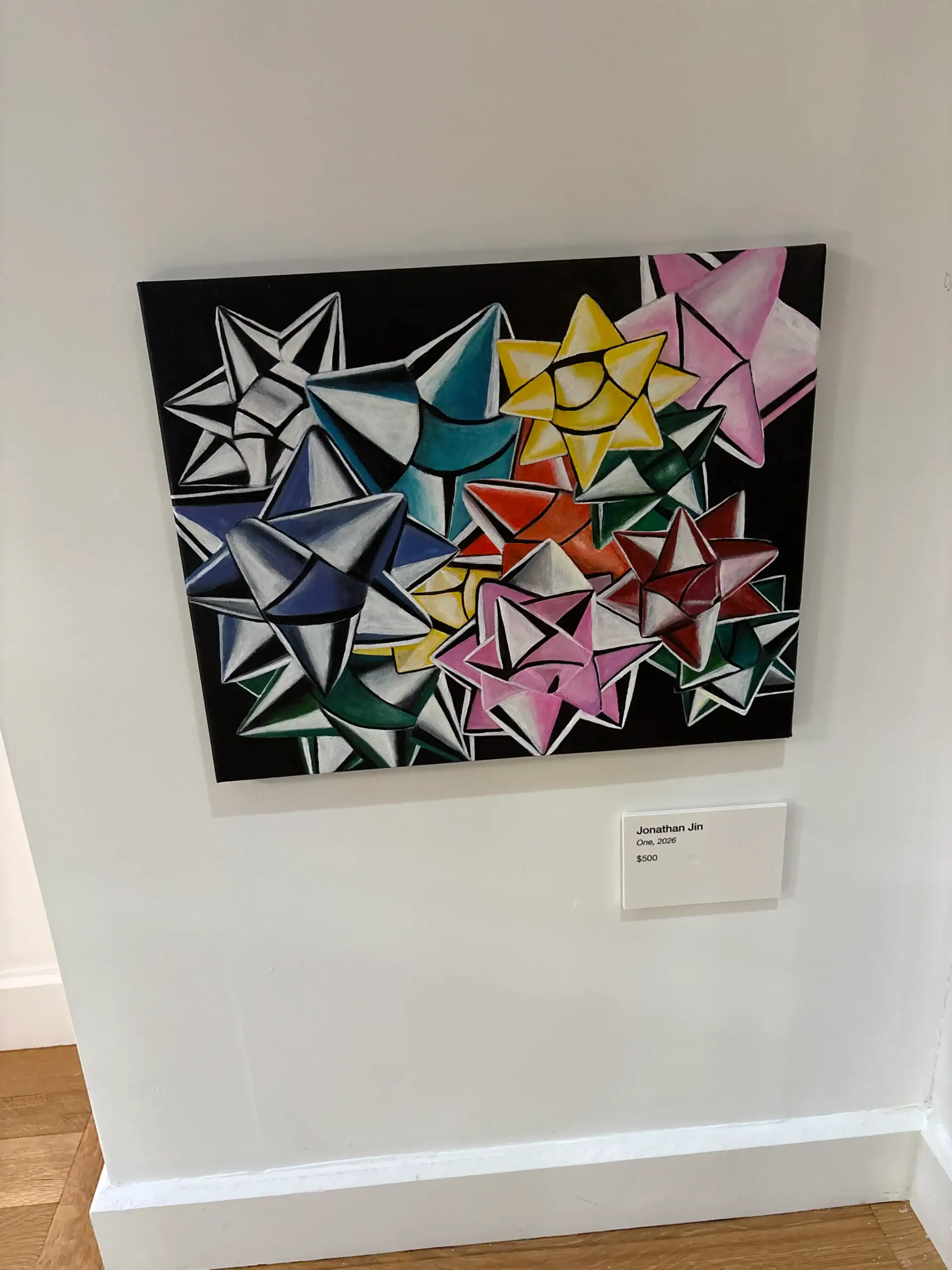 Colorful bow shapes overlap on a black background above a label at this NYC Wine Bar & Art Gallery.