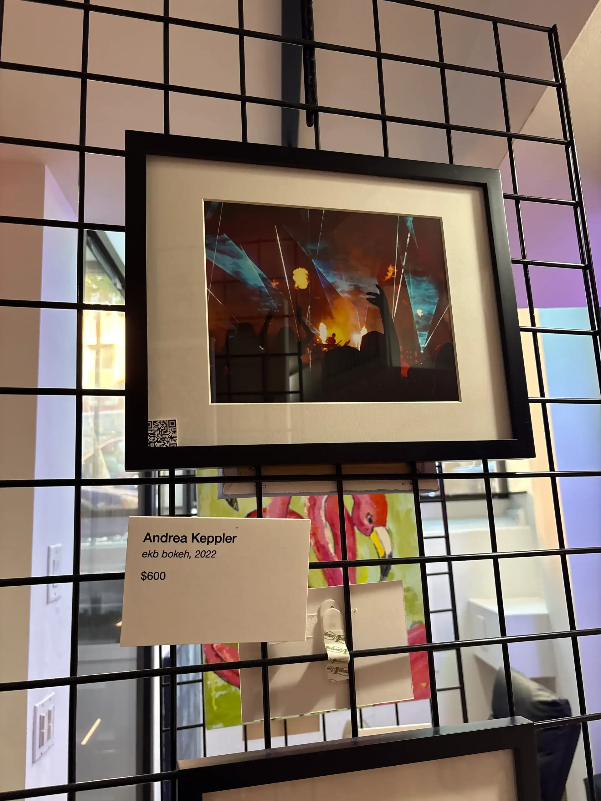 Abstract artwork with vibrant colors framed at Wine Bar & Art Gallery in NYC, price tag showing $600.