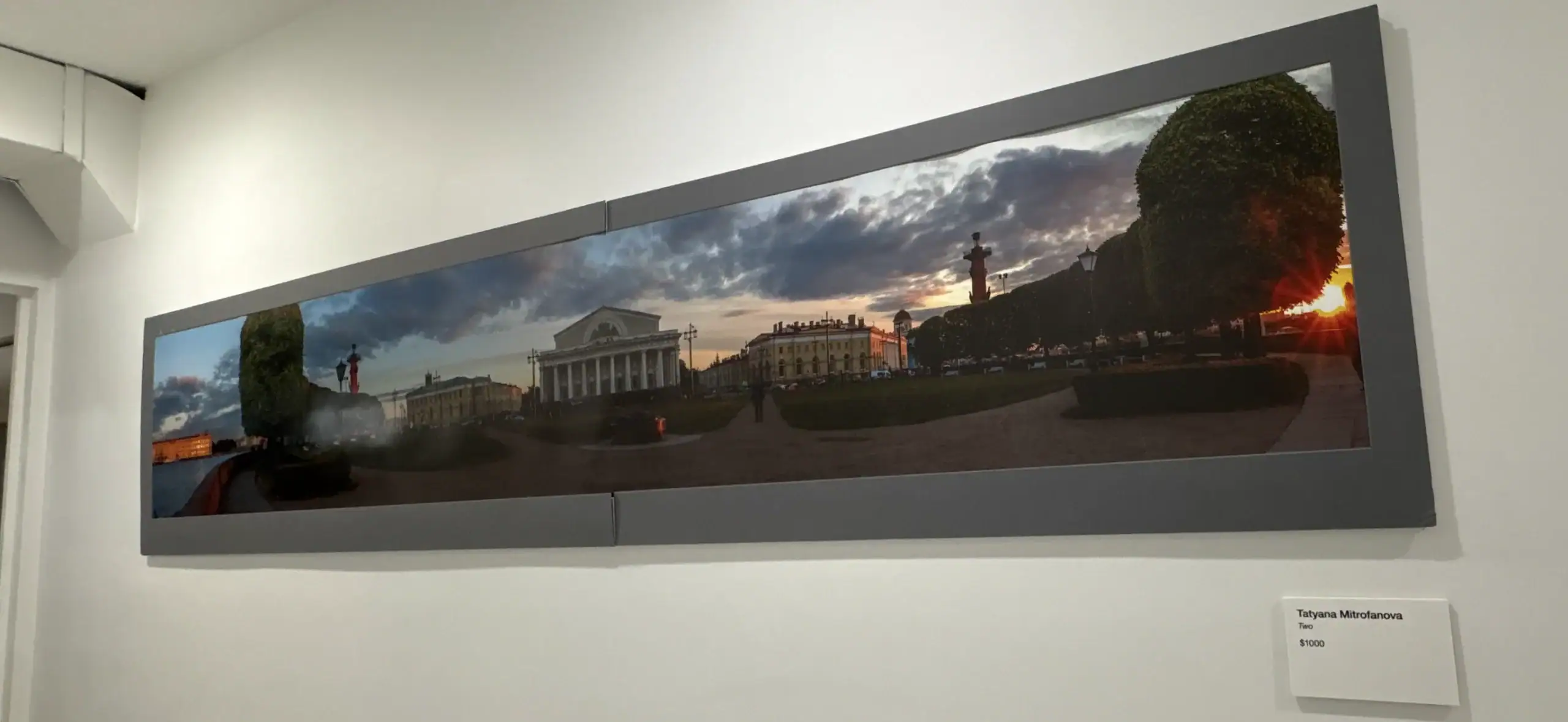 Panoramic photo of NYC city square at sunset, framed on a Wine Bar & Art Gallery wall.